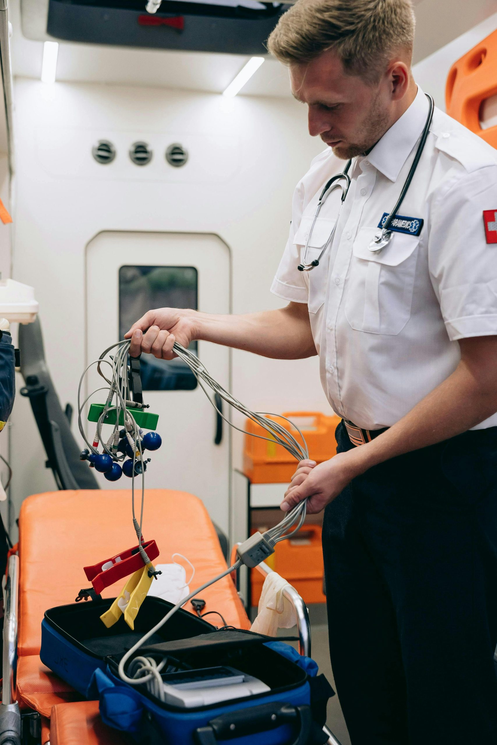 Paramedic organizing equipment in ambulance, showcasing emergency medical services.