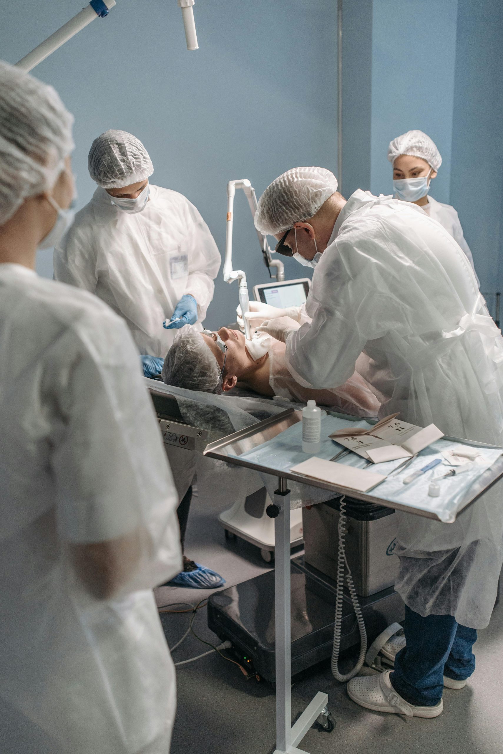 Doctors and nurses conducting a surgical procedure in a hospital operating room.